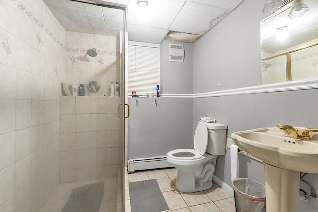 full bathroom featuring tile patterned floors, a shower stall, a baseboard radiator, and toilet