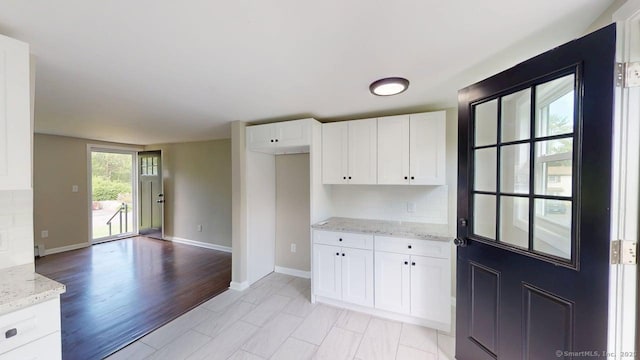 3 Richard Ln, Prospect, CT 06712 - kitchen featuring light stone counters, white cabinetry, and baseboards