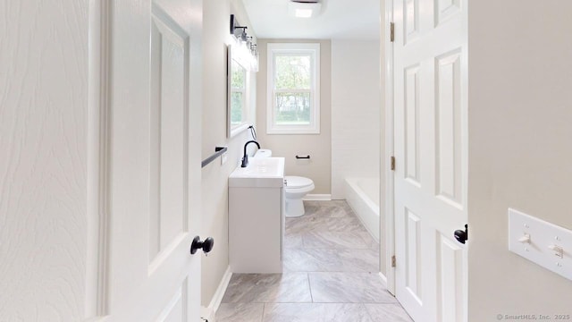 3 Richard Ln, Prospect, CT 06712 - bathroom featuring marble look tiles, toilet, vanity, a tub, and baseboards