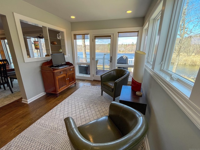 sunroom / solarium featuring wood finished floors, baseboards, and recessed lighting
