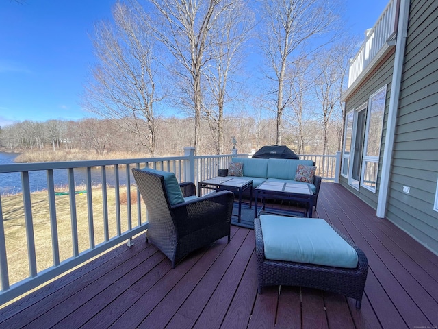 wooden deck featuring an outdoor living space and a water view