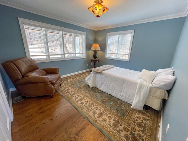 bedroom with wood finished floors, baseboards, and ornamental molding
