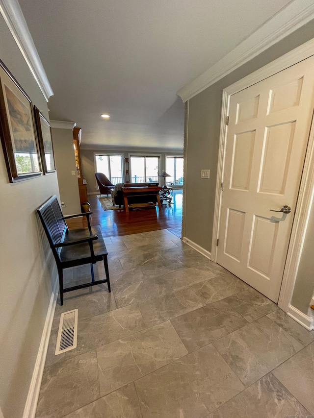 corridor featuring crown molding, baseboards, visible vents, and recessed lighting