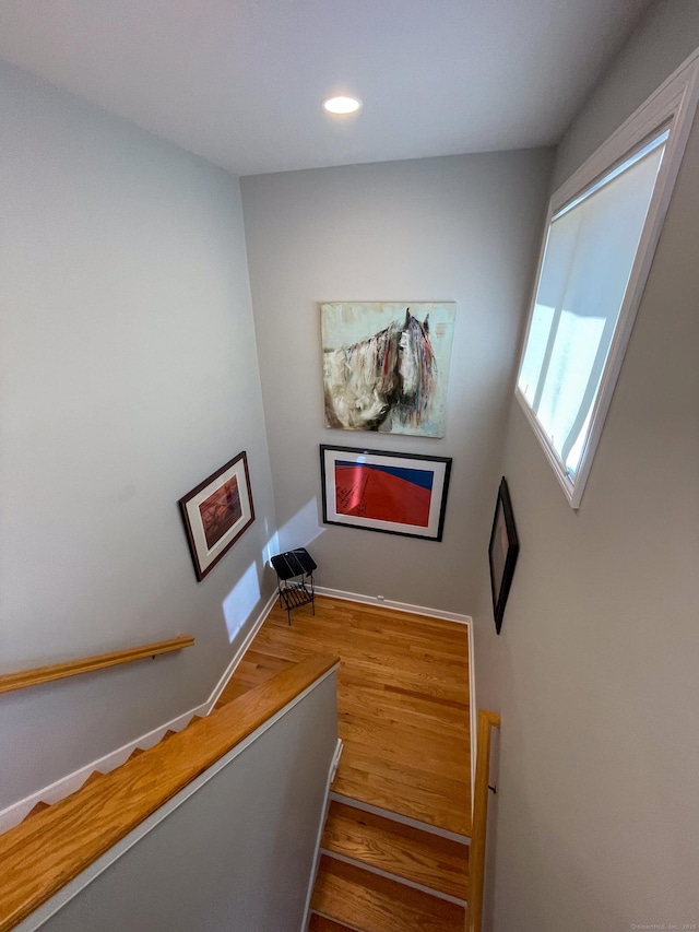 stairs with recessed lighting and wood finished floors