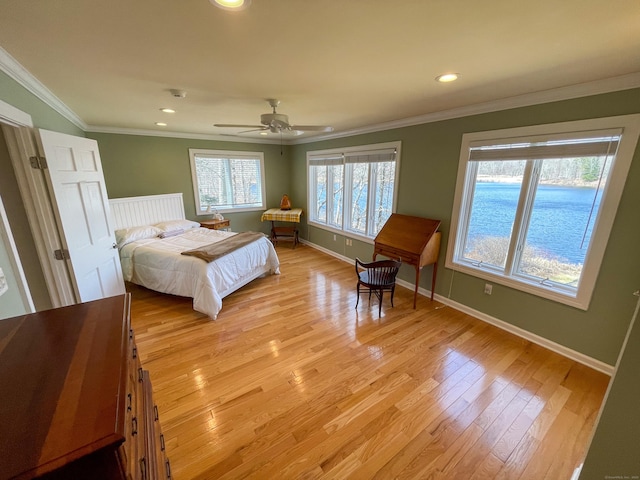 bedroom with recessed lighting, light wood-type flooring, baseboards, and crown molding