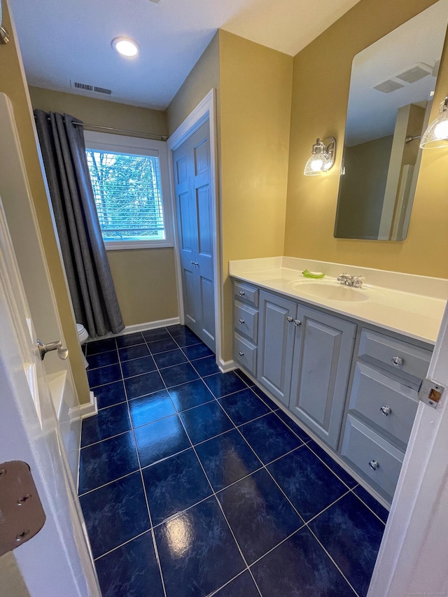 full bath with vanity, baseboards, tile patterned flooring, and visible vents