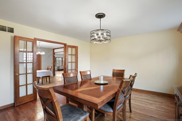 1069 Black Rock Tpke, Easton, CT 06612 - dining space with visible vents, an inviting chandelier, and wood finished floors