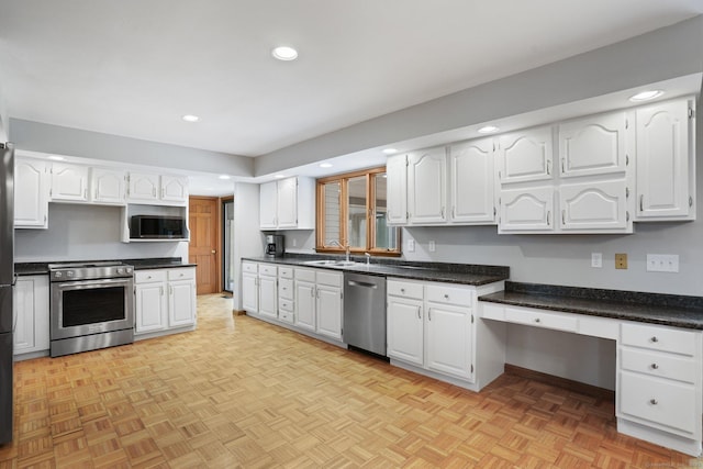 1069 Black Rock Tpke, Easton, CT 06612 - kitchen featuring recessed lighting, dark countertops, white cabinets, stainless steel appliances, and a sink