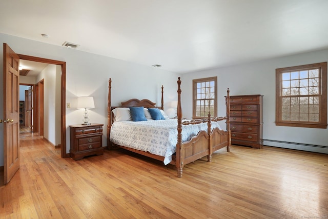1069 Black Rock Tpke, Easton, CT 06612 - bedroom with baseboard heating, light wood-style floors, baseboards, and visible vents