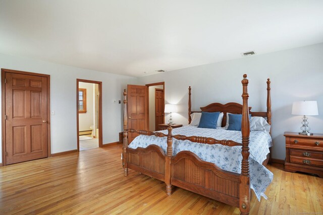 1069 Black Rock Tpke, Easton, CT 06612 - bedroom with baseboard heating, light wood-type flooring, baseboards, ensuite bathroom, and visible vents
