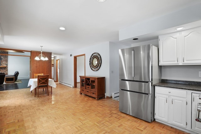 1069 Black Rock Tpke, Easton, CT 06612 - kitchen with a baseboard heating unit, freestanding refrigerator, dark countertops, and white cabinets