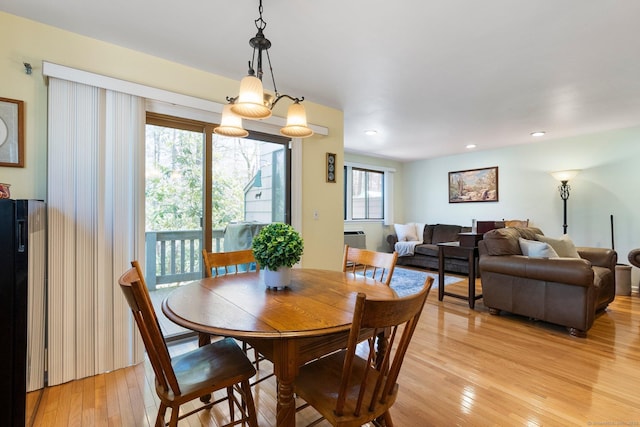 dining room featuring recessed lighting, light wood-style floors, and an AC wall unit