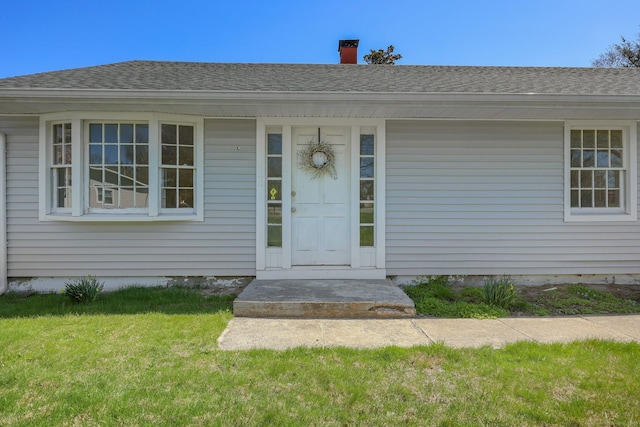 3456 Madison Ave, Bridgeport, CT 06606 - view of exterior entry with a lawn and a shingled roof