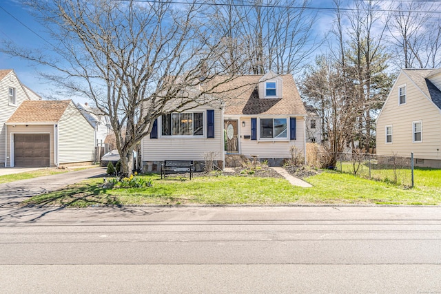 161 Boswell St, Stratford, CT 06615 - view of front of house featuring a front yard, aphalt driveway, fence, an outbuilding, and roof with shingles