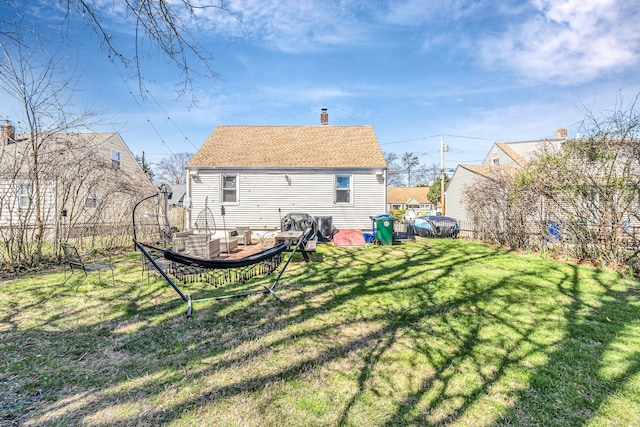 161 Boswell St, Stratford, CT 06615 - back of house featuring a shingled roof, a chimney, fence, and a lawn
