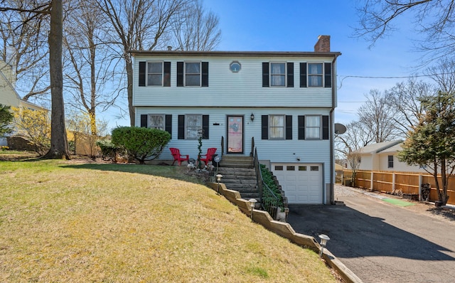 61 Harrington St, Meriden, CT 06451 - colonial house featuring a chimney, driveway, an attached garage, a front yard, and fence