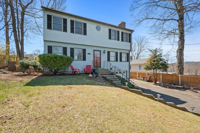 61 Harrington St, Meriden, CT 06451 - colonial home with fence, a front yard, and a chimney