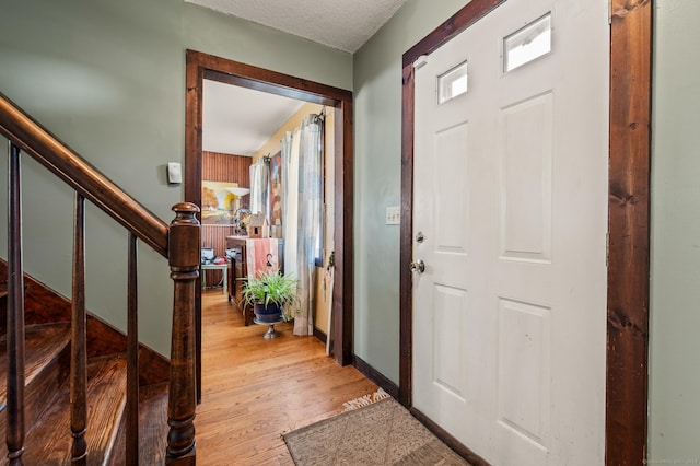 61 Harrington St, Meriden, CT 06451 - foyer entrance featuring stairs, light wood-style flooring, and a textured ceiling