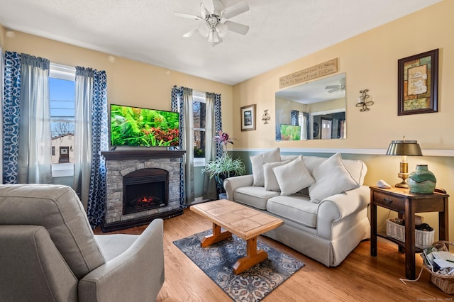 61 Harrington St, Meriden, CT 06451 - living area featuring a stone fireplace, wood finished floors, and ceiling fan