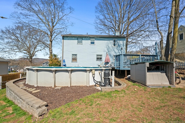 61 Harrington St, Meriden, CT 06451 - back of property with an outdoor pool, a chimney, a deck, and a yard