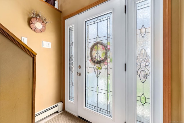 foyer with a baseboard radiator and carpet flooring