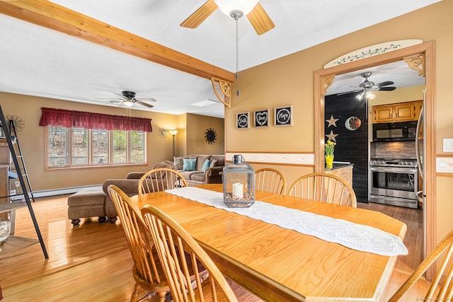 dining space featuring light wood finished floors, baseboard heating, beamed ceiling, and ceiling fan