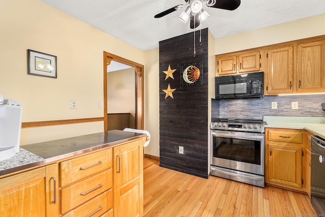 kitchen with ceiling fan, light wood-style flooring, black appliances, light countertops, and decorative backsplash