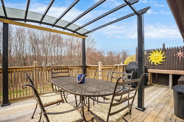 deck with outdoor dining space and a pergola