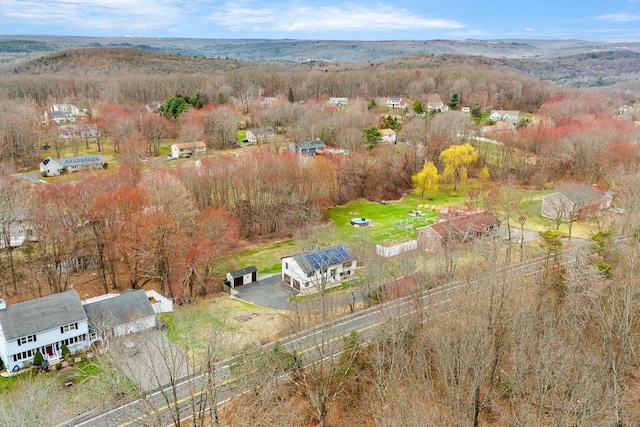 drone / aerial view featuring a wooded view