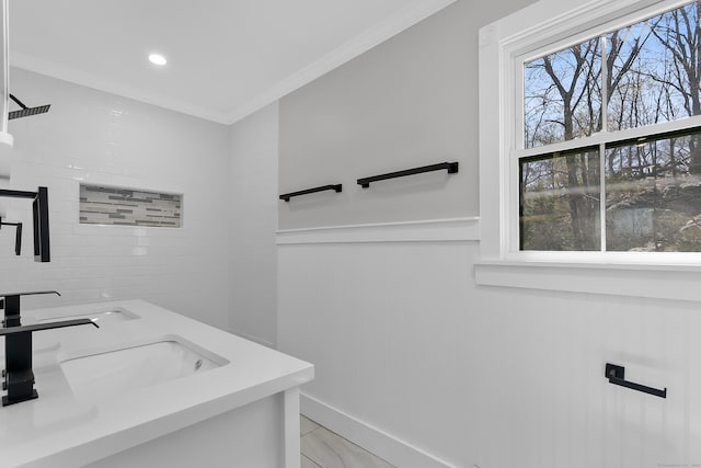 full bath featuring a sink, crown molding, and recessed lighting