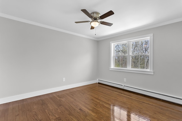 spare room with crown molding, a ceiling fan, baseboards, wood finished floors, and a baseboard radiator