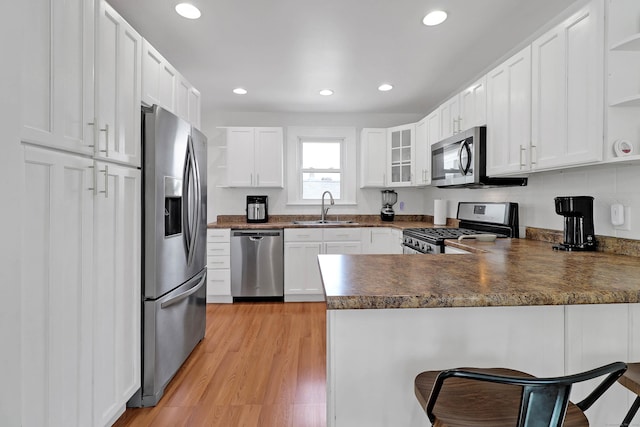 15 Smith St, Danbury, CT 06810 - kitchen featuring dark countertops, open shelves, a sink, stainless steel appliances, and a peninsula