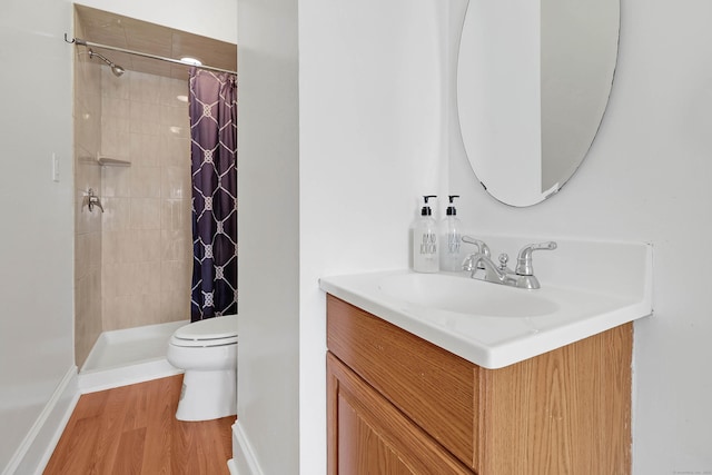 15 Smith St, Danbury, CT 06810 - bathroom featuring a tile shower, wood finished floors, toilet, vanity, and baseboards