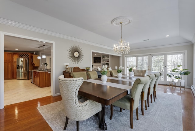 dining room with an inviting chandelier, light wood-style flooring, recessed lighting, visible vents, and ornamental molding