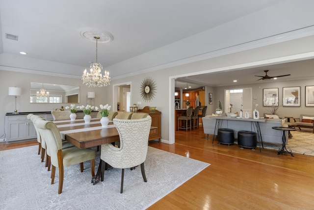 dining area with recessed lighting, visible vents, ornamental molding, and light wood-type flooring