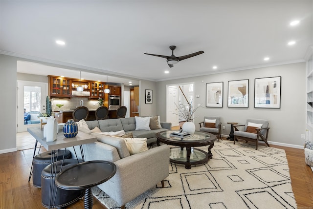 living room featuring recessed lighting, light wood-style flooring, and baseboards