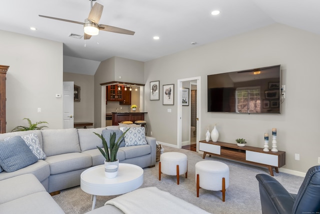 living room featuring baseboards, recessed lighting, bar, a ceiling fan, and vaulted ceiling