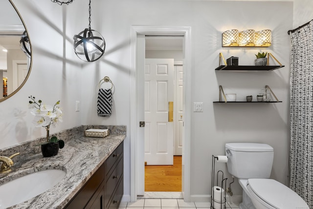 full bathroom featuring tile patterned flooring, vanity, toilet, baseboards, and ornamental molding