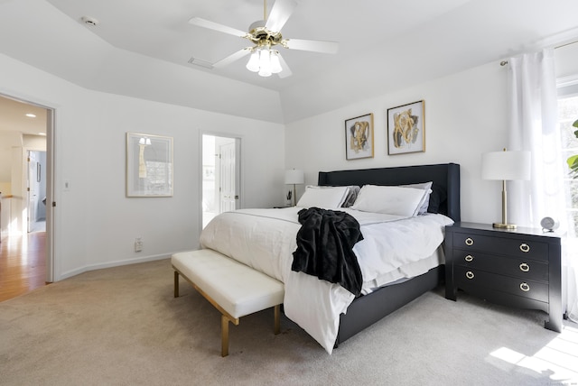 bedroom with baseboards, ceiling fan, light carpet, and visible vents