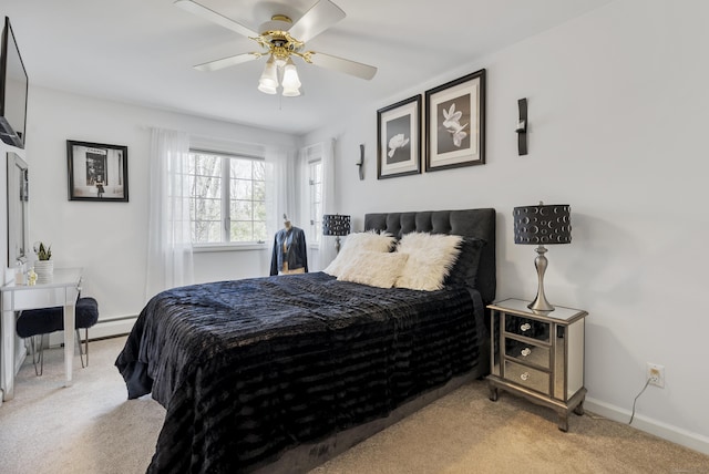 carpeted bedroom with a baseboard radiator, baseboards, and ceiling fan