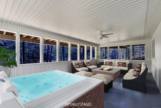 sunroom with a jacuzzi, an outdoor living space with a fire pit, and ceiling fan