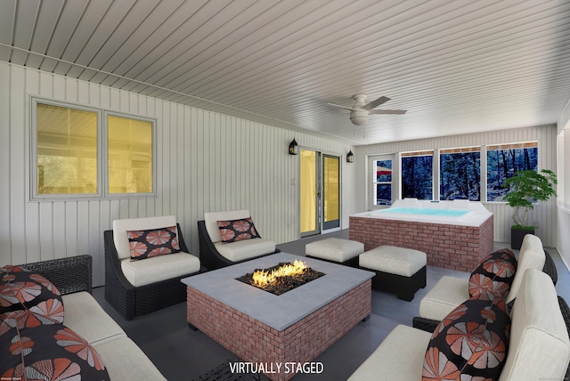 view of patio / terrace featuring a ceiling fan, an outdoor living space with a fire pit, and an outdoor hot tub