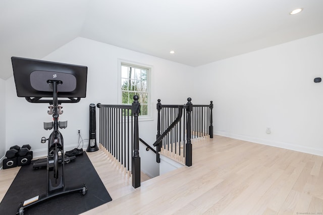 workout room featuring recessed lighting, baseboards, and wood finished floors