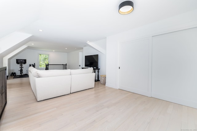 living room with light wood finished floors and recessed lighting