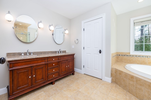 full bath with a sink, tile patterned floors, and double vanity