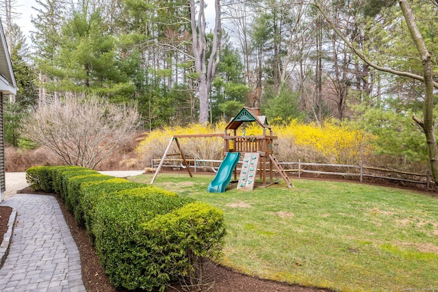 view of jungle gym with fence and a lawn