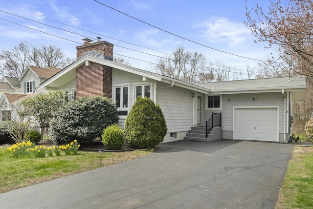 33 Cottage Ln, East Lyme, CT 06357 - view of front of house with aphalt driveway, a chimney, roof with shingles, and a garage