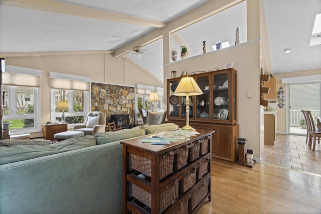 33 Cottage Ln, East Lyme, CT 06357 - living room with beam ceiling, a fireplace, light wood-style flooring, a ceiling fan, and baseboards