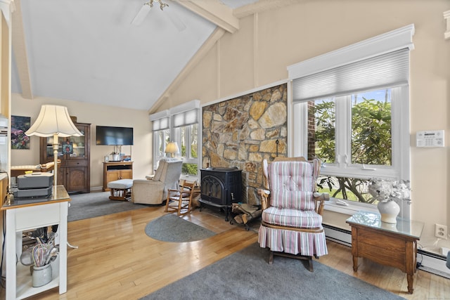 33 Cottage Ln, East Lyme, CT 06357 - living area with wood-type flooring, a wood stove, a ceiling fan, and high vaulted ceiling