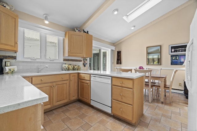 33 Cottage Ln, East Lyme, CT 06357 - kitchen featuring white dishwasher, light countertops, a sink, a peninsula, and lofted ceiling with skylight